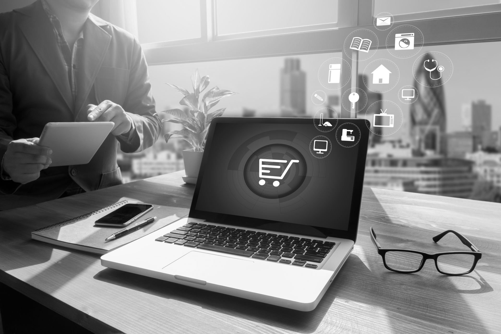 e-commerce icons on a businessman's laptop